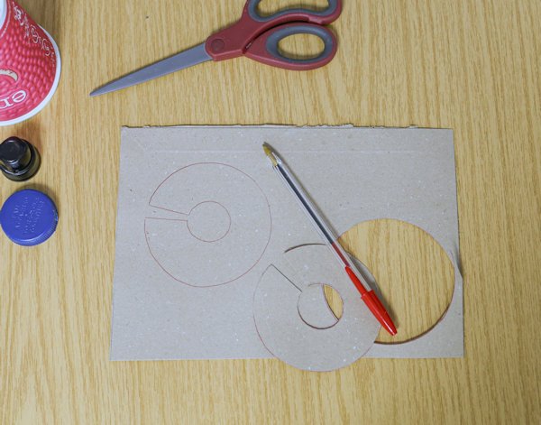 one piece of card cut out and being used as a template for the second piece